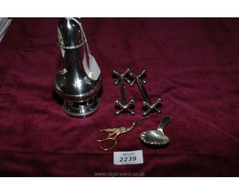 A 20th century silver plated sugar castor, a shell shape caddy spoon stamped D.M.G., a pair of quality knife rests and white 