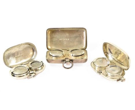 Three Silver Double-Sovereign Cases, two plain oval and with drop-ring handles, the third oblong and with engine-turned decor