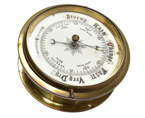 A brass bulkhead ships aneroid barometer, ceramic dial 6.5'', case width 21cm wide
