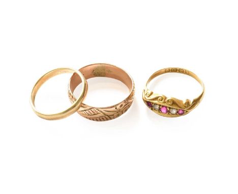 An 18 carat gold ruby and diamond five stone ring, finger size M; two 9 carat gold band rings, finger sizes K1/2 and O18 cara