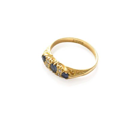 An 18 carat gold sapphire three stone ring, with diamond accents, finger size O1/2Gross weight 3.5 grams.