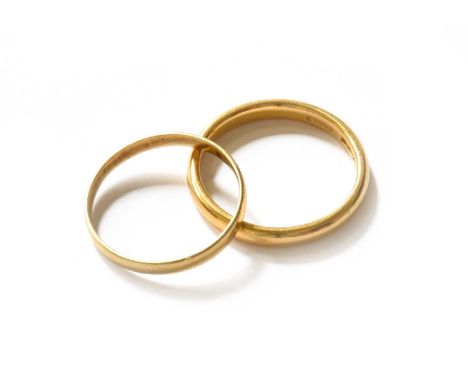 A 22 carat gold band ring, finger size M1/2; and an 18 carat gold band ring, finger size K1/222 carat gold band ring - 3.5 gr