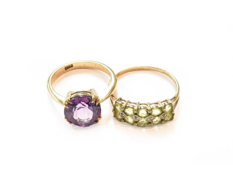 A synthetic sapphire simulating alexandrite ring, stamped '9CT', finger size Q; and a 9 carat gold peridot and diamond ring, 