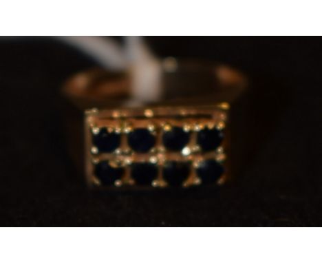A gentleman's rectangular sapphire panel ring, platform top inset with two rows of four round cut blue sapphires, block shoul