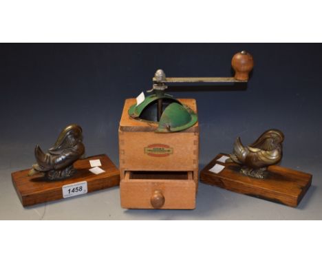 A pair of Art Deco bookends, modelled as fantail ducks; a coffee grinder (3)