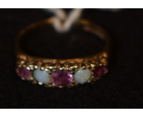 An opal and pale pink ruby quintet ring, alternate set woth three graduating ellipse cut pale pink ruby's and two round opal 