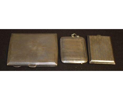 A silver rounded rectangular cigarette case, engine turned, Chester 1928; a silver rounded rectangular vesta case, engine tur