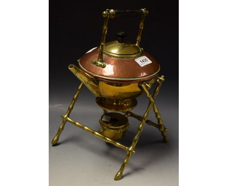 A brass and copper spirit kettle, aesthetic movement, bamboo style stand, Benson style 