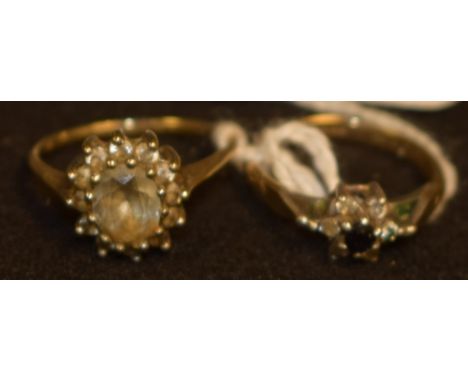 A 9ct gold lady's dress ring, hallmarked, 2.24g gross; another, gold-plated sterling silver, 2.08g gross (2) 