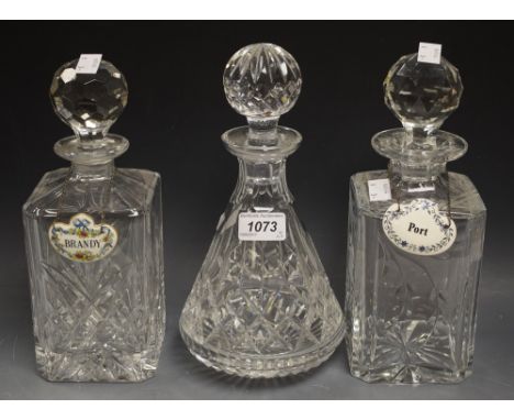 A matched pair of lead crystal square decanters and stoppers; another conical with two decanter labels, Port and Brandy (5)