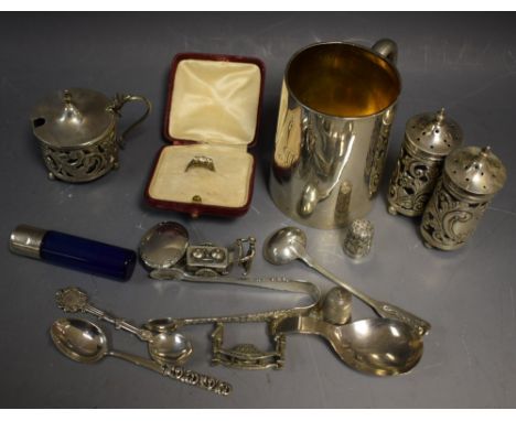 A silver mug, London 1877; a silver cruet, Birmingham 1903, blue glass liners; a silver sauce spoon, London 1824; a caddy spo