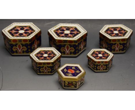 Royal Crown Derby - a set of four hexagonal graduated lidded trinket boxes, 1297 pattern; sixes from 6.5cm to 4cm; two others