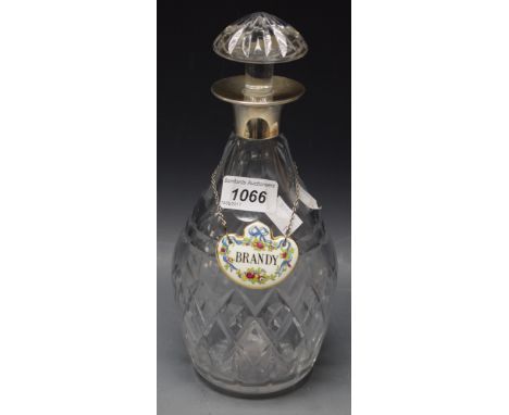 A cut glass decanter with silver collar, Birmingham 1979, with Coalport ceramic Brandy label