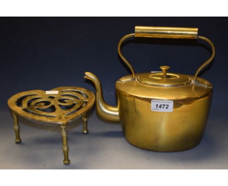 A Victorian brass heart shaped trivet and brass kettle