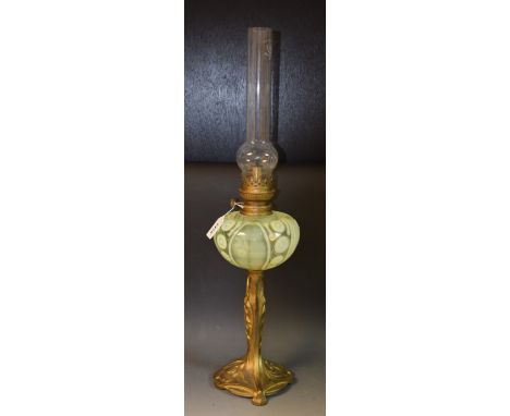 A French Art Nouveau parcel gilt oil lamp, the pedestal base cast with bluebells and swirling fluid forms, ovoid vaseline gla