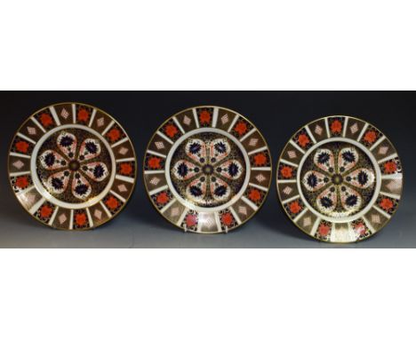 A pair of Royal Crown Derby Imari 1128 pattern dinner plates, seconds; another 1128 pattern dinner plate, first quality (3)