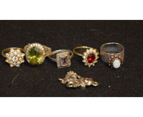 Jewellery - a lady's silver and opal ring, the bezel set with garnet-type stones, textured band, 4.02g gross; other lady's si