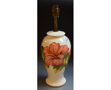 A contemporary Moorcroft Hibiscus pattern ovoid table lamp, tubelined and decorated in autumnal tones on a cream ground, 39cm