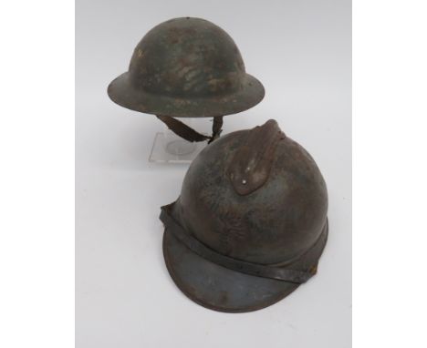 WW2 British and French Helmetsconsisting green painted, raw edge MKI steel helmet.  Black treated linen liner with fibre fram