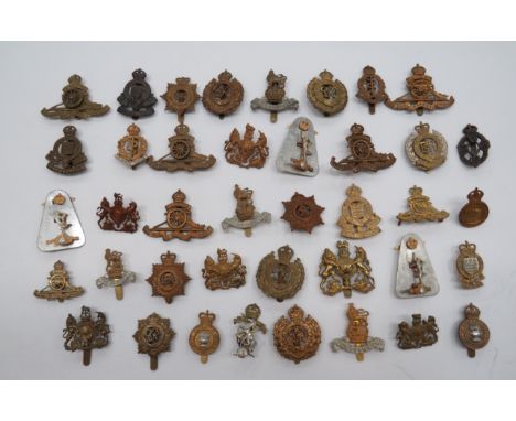 Quantity of Corps Cap Badgesincluding KC plastic economy REME ... KC bi-metal Royal Corps of Signals (2 part) ... KC brass RA