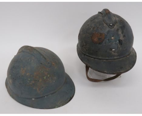 Two WW1 French 'Adrian' Pattern Steel Helmetsblue painted crown.  Attached top comb.  Attached front peak and rear brim with 