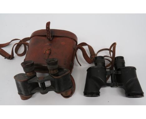 Two Pairs of Commonwealth Issue Binocularsconsisting pair of 6 x 30 binoculars.  Brass frames with broad arrow issue stamps. 