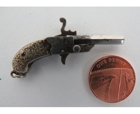 Miniature Pinfire Watch Chain Pistol3/4 inch, plated octagonal barrel.  Plated frame with pinfire working hammer and trigger.