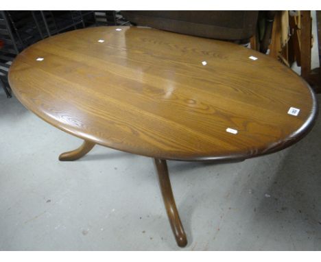 An Ercol or similar darkwood oval coffee table, a nest of three coffee tables &amp; a linen-fold drop-leaf trolley together w