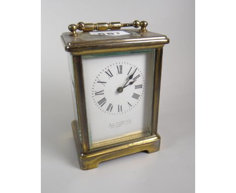 A brass encased carriage clock with white enamel dial bearing Roman numerals &amp; inscribed E J Fairbairns Condition Report: