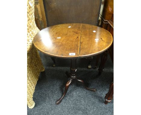 An antique elm circular top tripod table, 70cm high Condition Report: please request via email. Condition reports not stated 