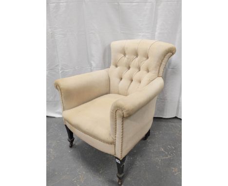Button back armchair on tapered supports with castors. 82cm highCondition report:Scuff marks and fading to feet especially to