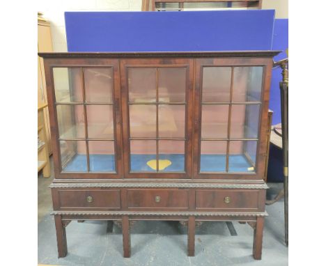 Chippendale style mahogany display cabinet with three glazed doors enclosing glass shelves above three small drawers. 151cm h