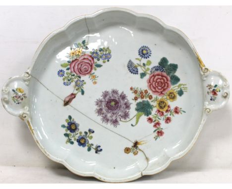 18th century Chinese porcelain tray of lobed twin handled form with polychrome enamel and gilt painted floral sprays, stapled