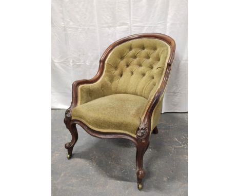 Victorian mahogany tub armchair with a shaped frame, upholstered in later button back fabric, on scroll supports with brass c