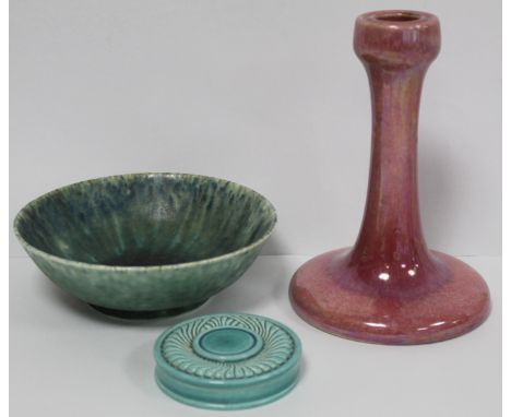 Ruskin Pottery high fired pink lustre candlestick of tapered column form with circular domed foot, 17.5cm high, impressed mar