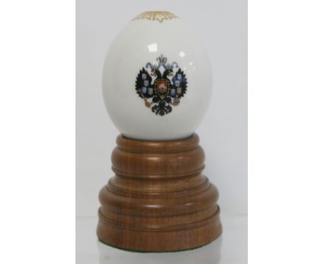 Russian porcelain presentation Easter egg with small polychrome enamel painted double headed eagle, gilding to top rim and gi