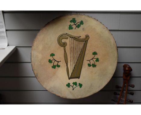 A traditional bodhran drum , with Celtic harp and clover design to skin, diameter approx. 45cm