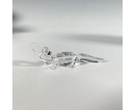 A precious cut crystal figure of a baby alligator with a clear crystal body and iridescent eyes. Part of the Endangered Speci