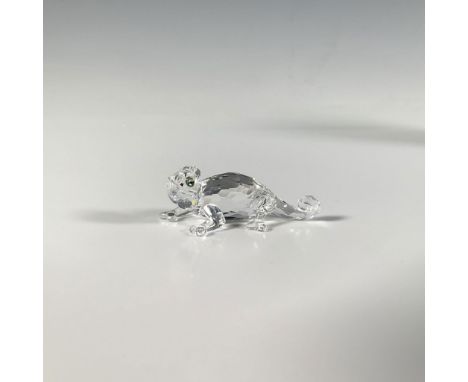 This vibrant cut crystal figure of a tiny reptile is crafted from clear crystal with iridescent eyes. Swarovski marking. This