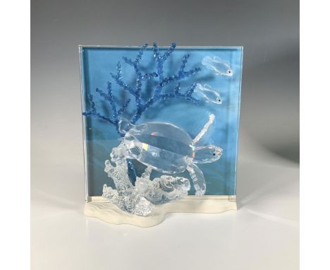 This radiant sculpture is part of the Wonders of the Sea trilogy. It features a turtle swimming near a clear and frosted cora