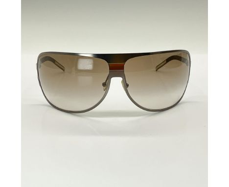 Wrap around style, metal frame. Light brown gradient lenses. Frame size: 83/11/110. Glasses measure: 5.75"L x 2.25"H. Marked 