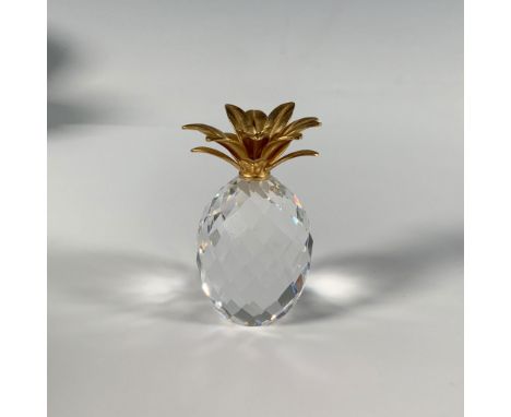 A charming faceted crystal figure in the shape of a pineapple with smooth gilded leaves. Swarovski marking. This item has its