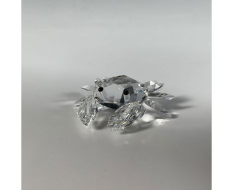 A charming fine-cut crystal crab, intricately crafted with delicate legs and accented with black eyes. Swarovski mark. This i