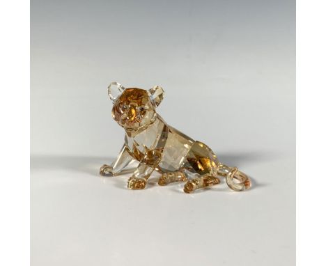 A sophisticated faceted golden crystal figure of a young tiger with blue eyes and an orange nose. SCS 2010 Companion piece. S