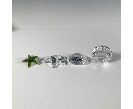This brilliant set of cut crystal figures includes a green starfish with its frosted rock base, a clear starfish, a clear sca