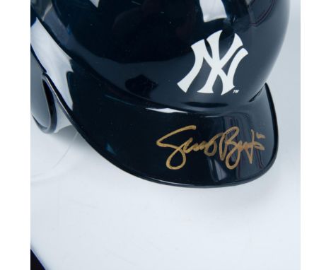 This is a miniature of an official MLB batting helmet with New York Yankees logo on the front and signed in gold by Scott Bro