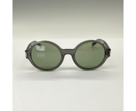 These luxury frames feature circular lenses set in full-rim translucent grey plastic, offering a bold yet stylish flair. Desi
