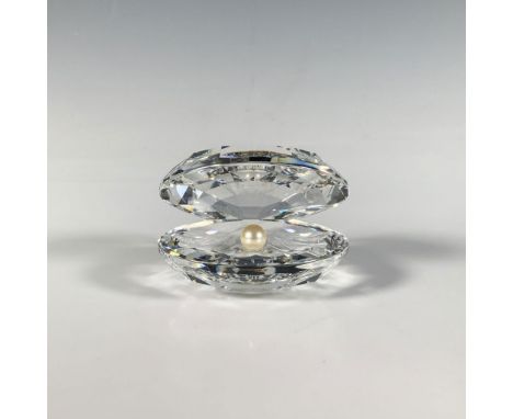 An exquisite cut crystal figure in the shape of an open clam shell adorned with a stunning pearl on the inside. Swarovski mar