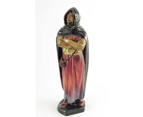 A Royal Doulton figure, HN1657, introduced 1938, painted green, red and blue cloack, orange, yellow sash, printed and painted