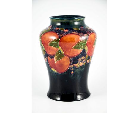 William Moorcroft, a Pomegranate on ochre and blue vase, circa 1915, inverse baluster form, impressed Burslem marks and unger